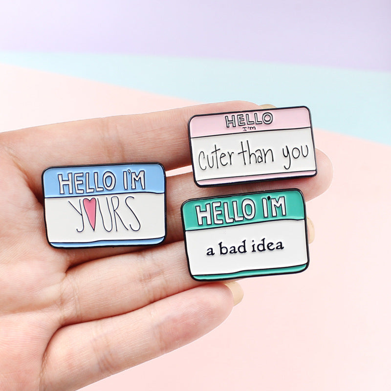 Hello I’m Enamel Pin  Material: Alloy Style: cartoon Style: Unisex Modeling: Letters Treatment process: dripping oil Packaging: Individually packed  Hello I’m yours, hello I’m cuter than you,Hello I’m a bad idea, I’m a stupid baby, don’t forget to save Color: CC1025, CC1026, CC1027, CC1028, CC1029